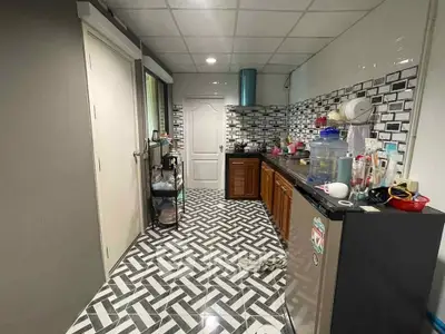 Modern kitchen with stylish geometric floor tiles and sleek cabinetry