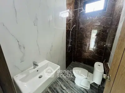 Modern bathroom with elegant marble tiles and sleek fixtures