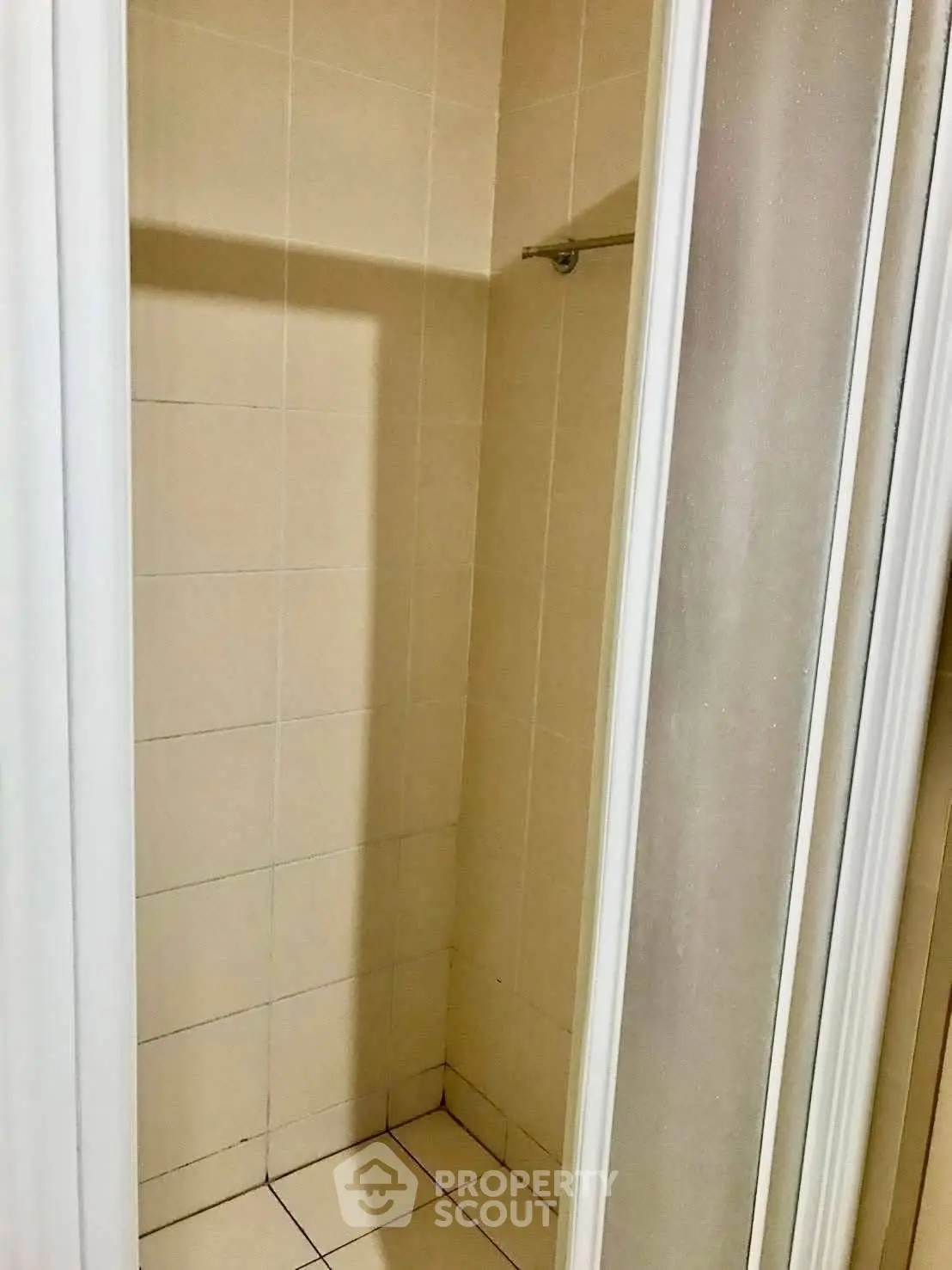 Compact shower area with tiled walls and sliding door
