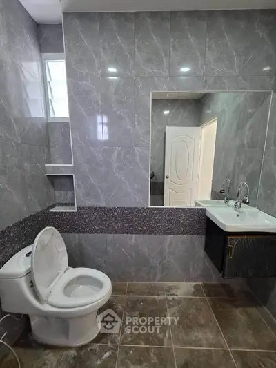 Modern bathroom with sleek gray tiles and contemporary fixtures