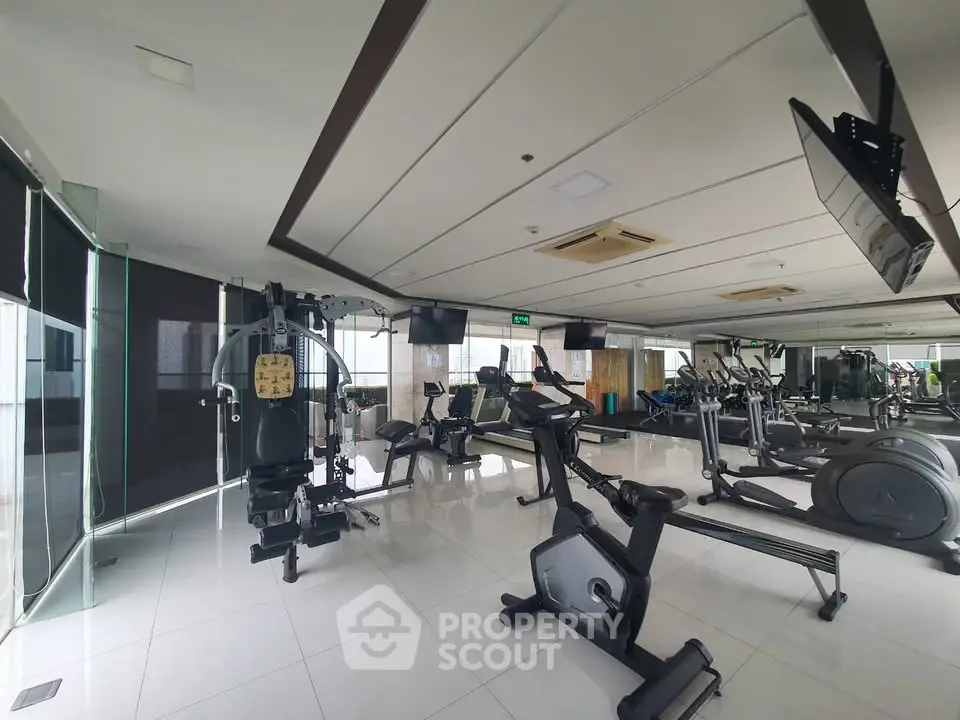 Spacious modern gym with state-of-the-art equipment and sleek design