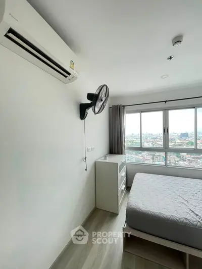 Modern bedroom with city view, featuring air conditioning and minimalist decor.