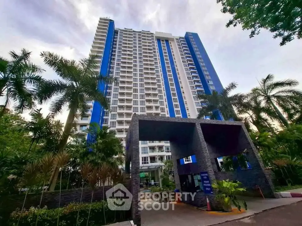 Stunning high-rise building with modern architecture and lush landscaping, perfect for urban living.