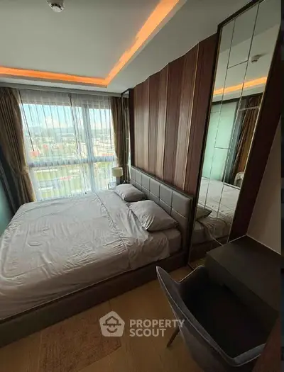 Modern bedroom with large window and stylish decor in high-rise apartment