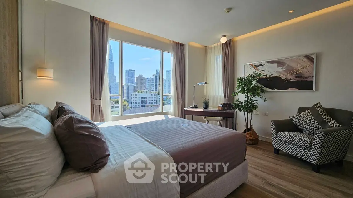 Luxurious bedroom with stunning city view, modern decor, and ample natural light in prime urban location.