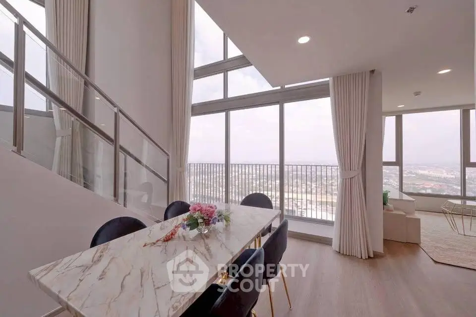 Luxurious high-rise apartment with stunning city view and elegant dining area.