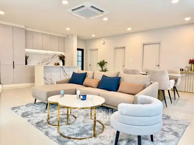 Spacious modern living room with elegant decor and open kitchen layout