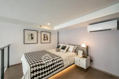Modern bedroom with stylish decor and air conditioning in a contemporary apartment.