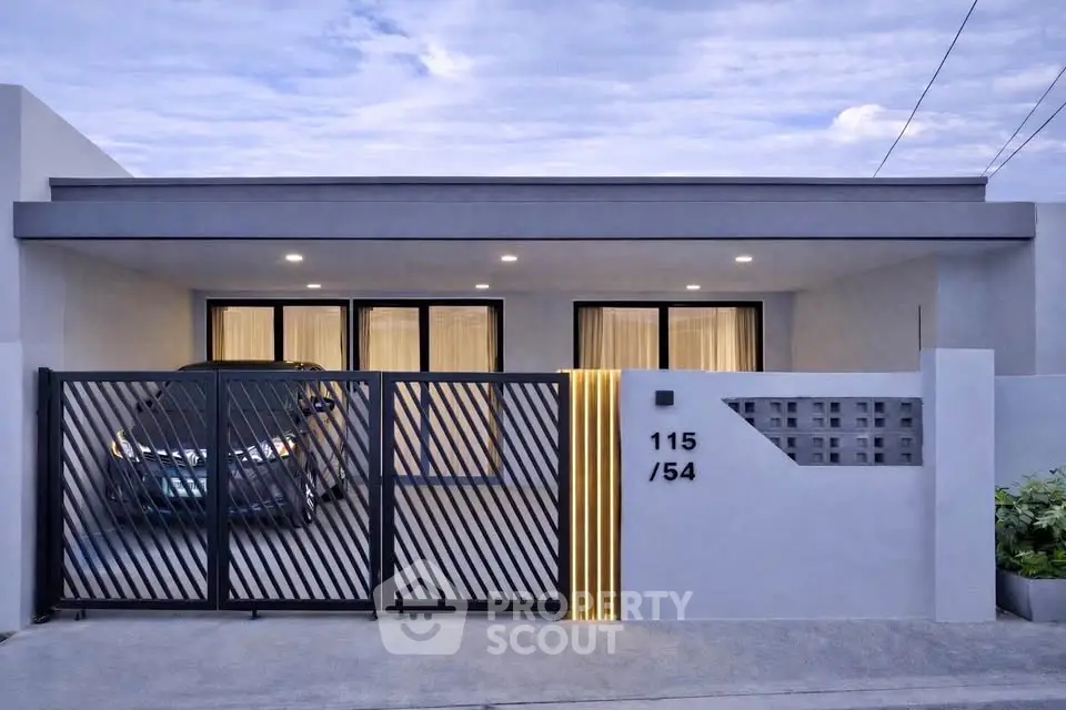 Modern single-story home with sleek design and gated driveway, perfect for contemporary living.