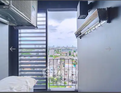 Stunning city view from a modern balcony with laundry rack and air conditioning unit.