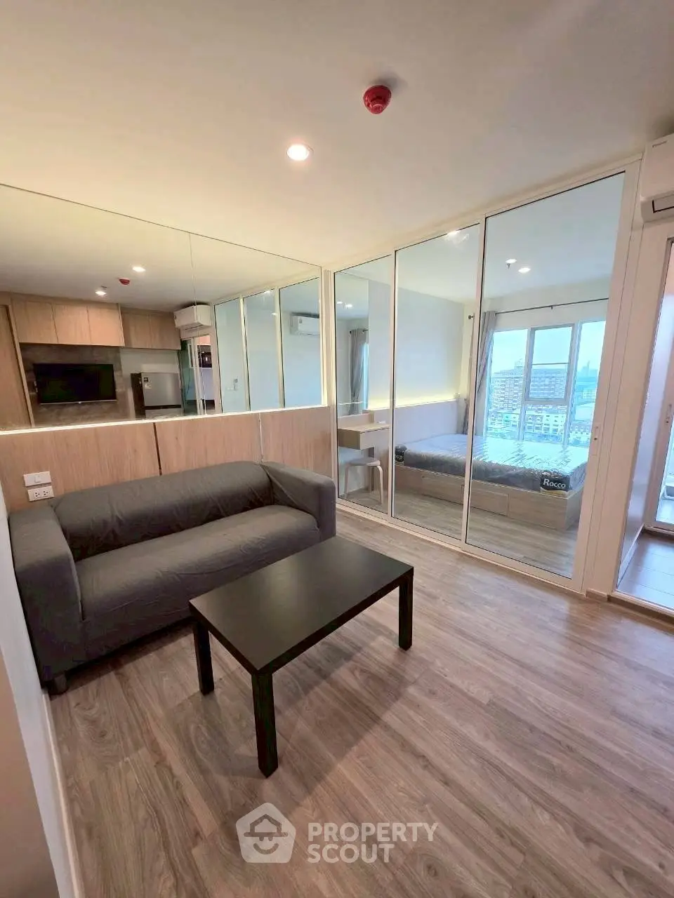 Modern open-plan living room with sleek kitchen and city view