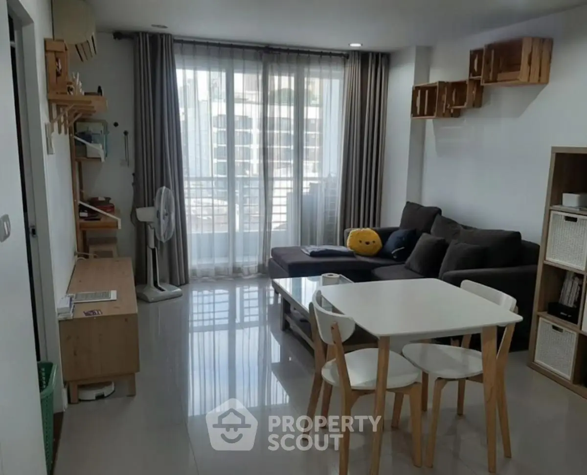 Modern living room with sleek furniture and large windows in a stylish apartment.