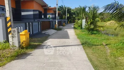 Modern residential street with contemporary houses and lush greenery