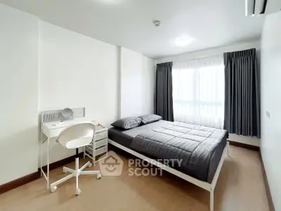 Modern bedroom with sleek design, featuring a comfortable bed and a stylish study area.
