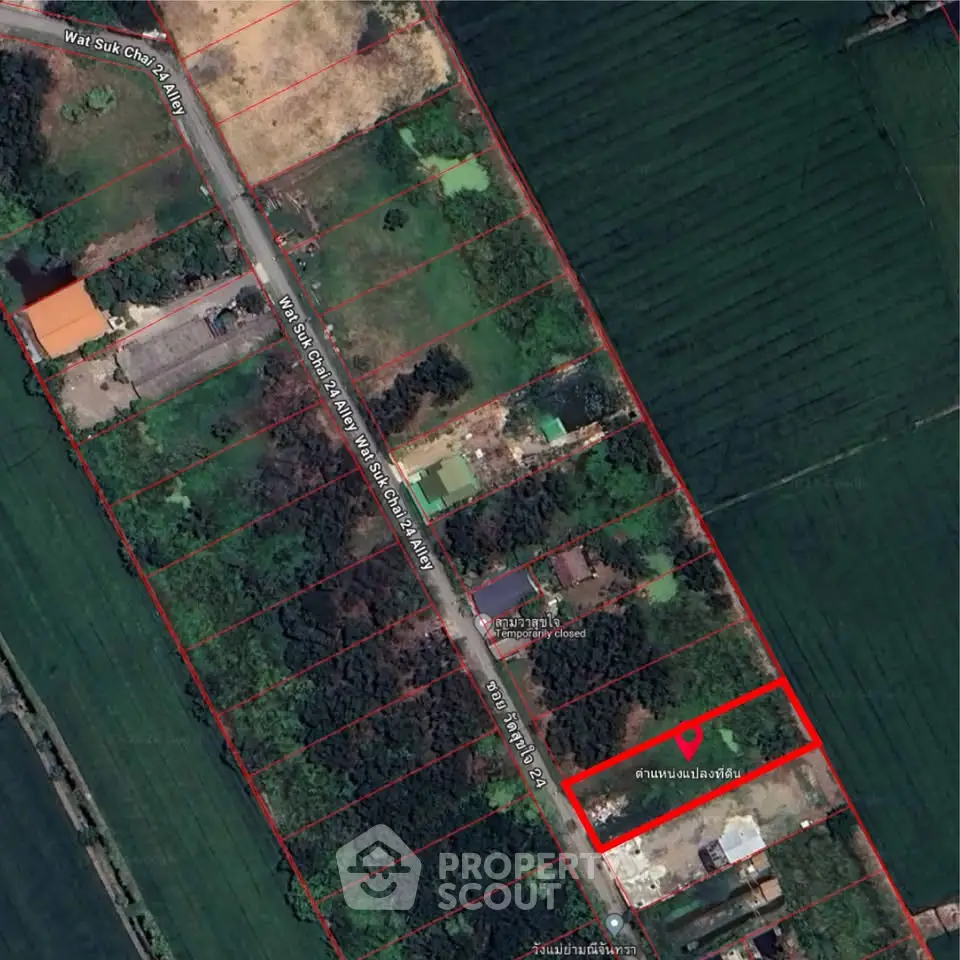 Aerial view of subdivided land plots with road access in a lush green area.