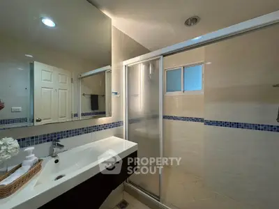 Modern bathroom with sleek fixtures and spacious shower area
