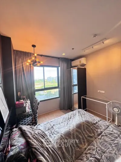 Cozy bedroom with large window and modern decor in urban apartment