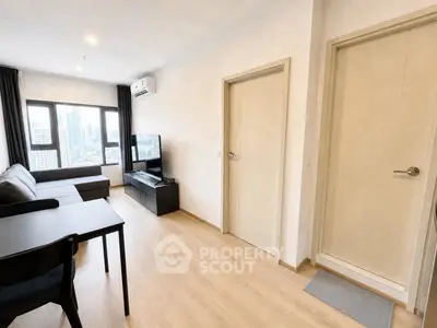 Modern living room with city view, featuring sleek furniture and natural light.