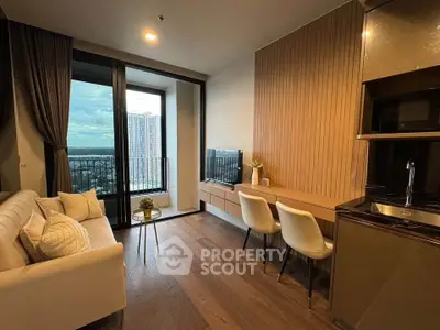 Modern living room with city view, elegant decor, and compact kitchen area.