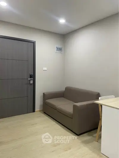 Modern living room with sleek sofa and minimalist decor, perfect for cozy urban living.