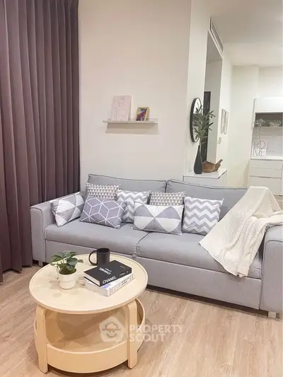 Modern living room with stylish gray sofa and geometric pillows, cozy ambiance