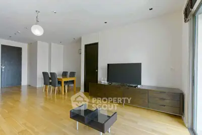 Spacious modern living room with wooden flooring and sleek furniture