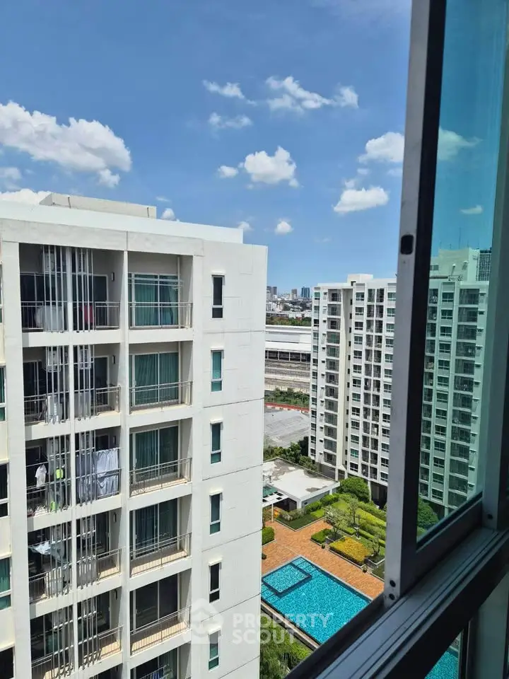 Stunning high-rise apartment view with pool and cityscape, perfect for urban living.