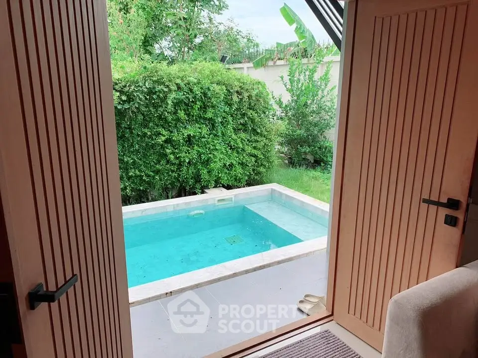 Charming view of a private pool from a cozy interior, perfect for relaxation and leisure.