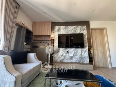 Modern living room with stylish decor and large TV setup