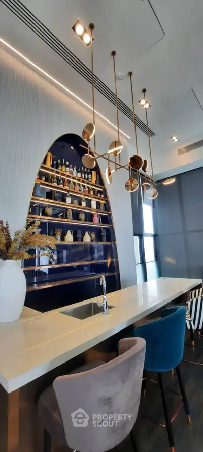 Luxurious modern kitchen with elegant bar seating and stylish lighting