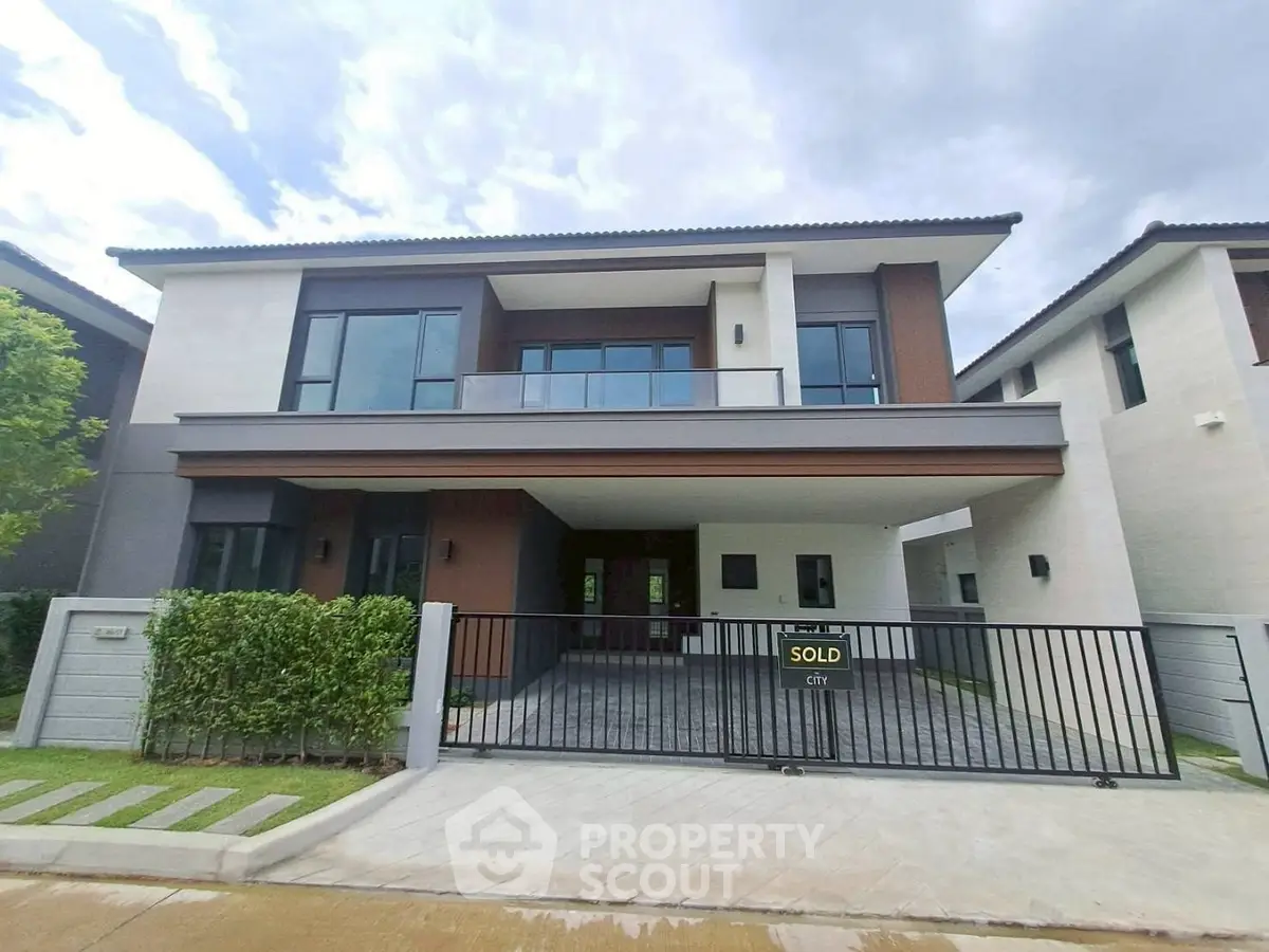 Modern two-story house with sleek design and spacious balcony, perfect for family living.