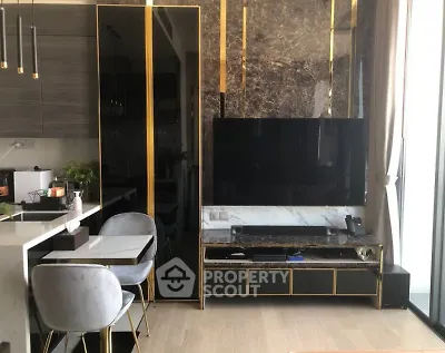 Luxurious modern living room with elegant marble accents and sleek furniture design.