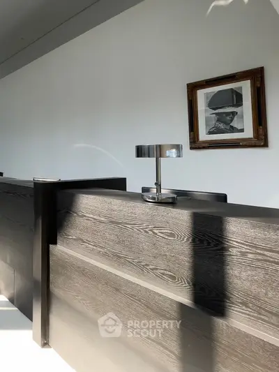Modern reception desk with sleek design and framed artwork on wall