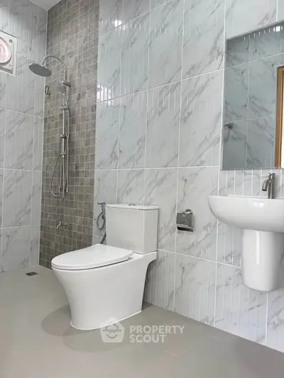 Modern bathroom with sleek fixtures and elegant tile design.
