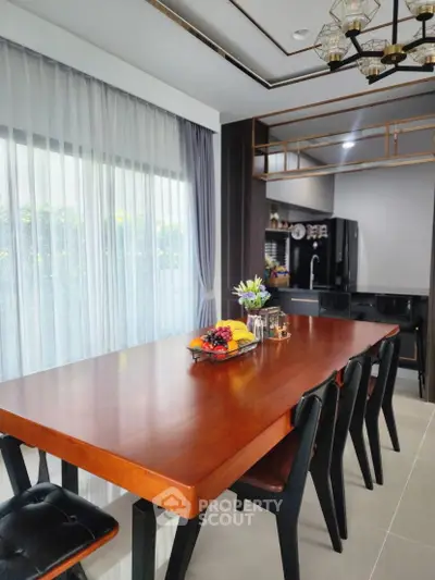 Modern dining area with elegant wooden table and sleek kitchen design