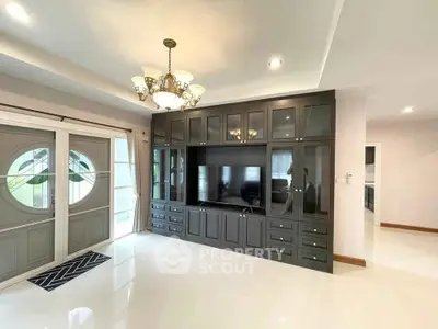 Elegant living room with built-in entertainment center and chandelier lighting
