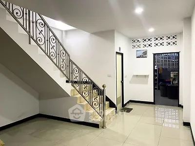 Spacious modern interior with elegant staircase and polished tile flooring