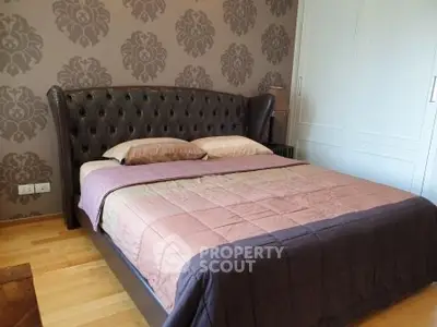 Luxurious bedroom with elegant decor and plush bedding in a modern apartment.