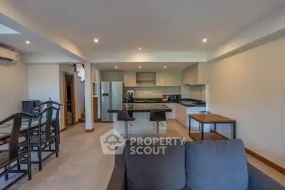 Spacious open-plan kitchen and living area with modern furnishings and ample natural light.