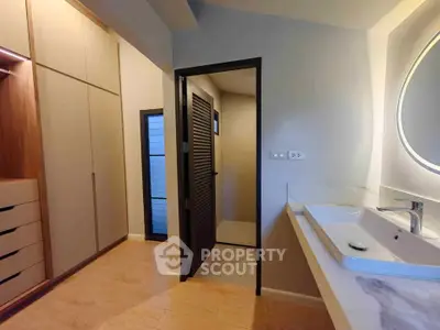 Modern bathroom with sleek sink and spacious closet area