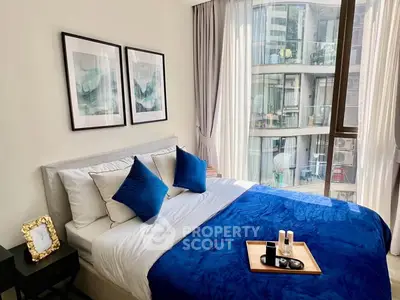 Elegant bedroom with modern decor and large window offering city view