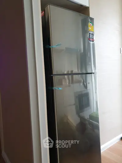 Modern kitchen with sleek stainless steel refrigerator and built-in microwave