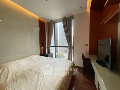 Modern bedroom with large window and city view, featuring sleek furniture and ambient lighting.