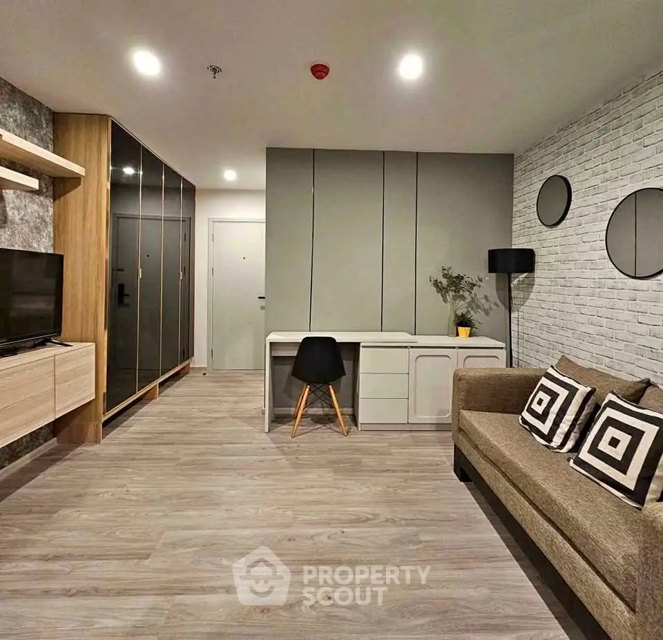 Modern living room with stylish decor, featuring a cozy sofa, sleek desk, and ample storage space.