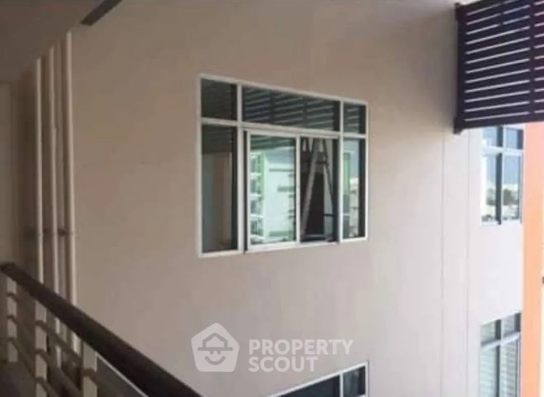 Modern apartment building exterior with balcony and large windows