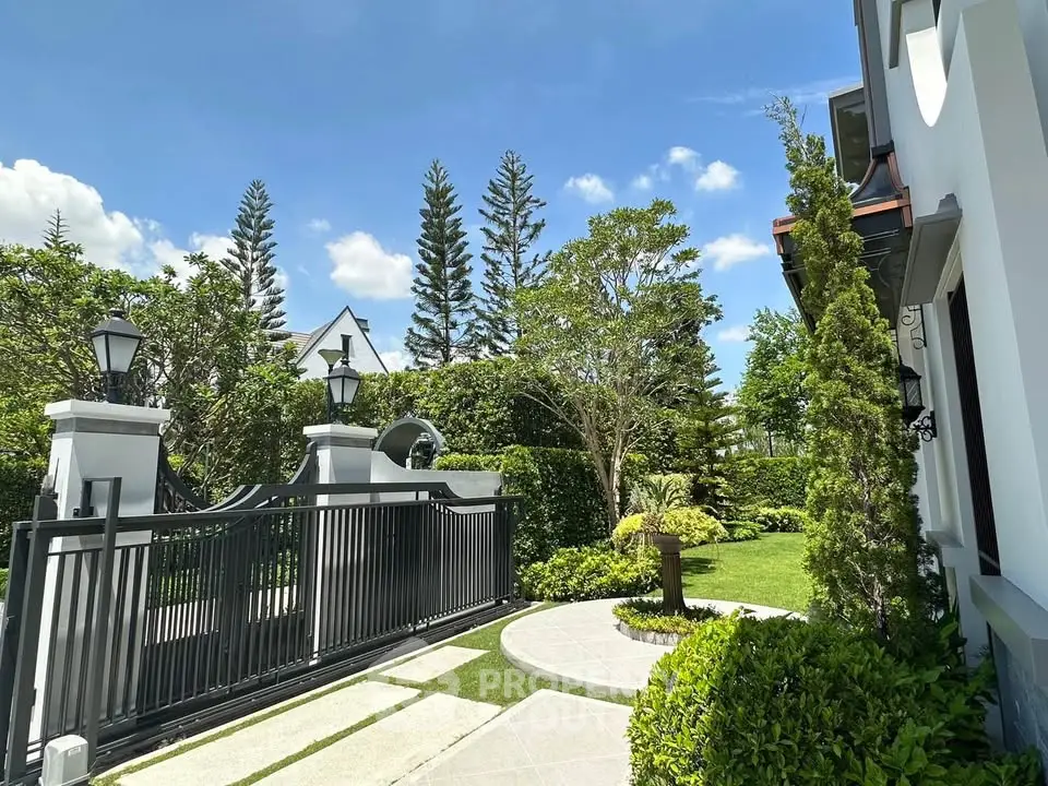 Luxurious garden entrance with elegant gate and lush greenery, perfect for upscale living.