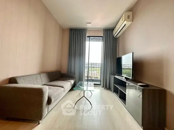 Modern living room with sleek furniture and balcony view