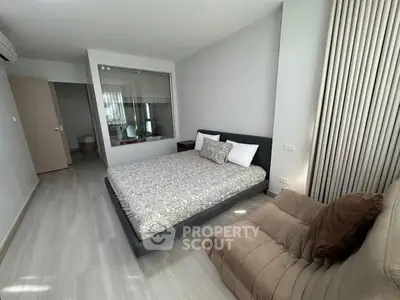 Modern bedroom with stylish decor and cozy seating area