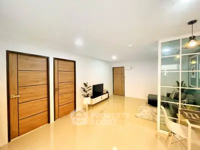 Modern living room with sleek design, glass partition, and stylish decor