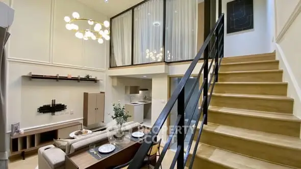 Modern duplex living room with elegant staircase and open kitchen layout